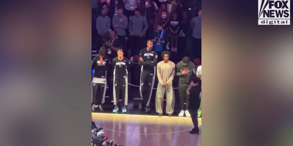 Spurs star stands arms crossed during the national anthem before Game 5
