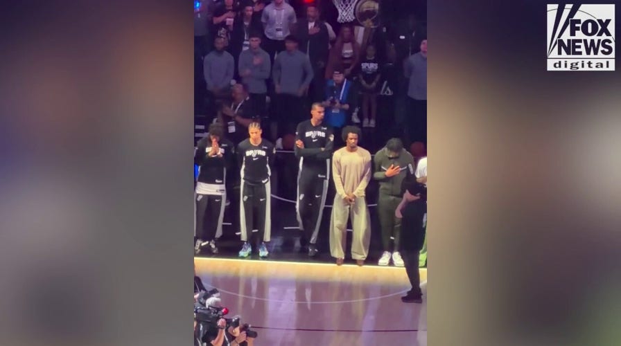 Spurs prima  stands arms crossed during the nationalist  anthem earlier  Game 5