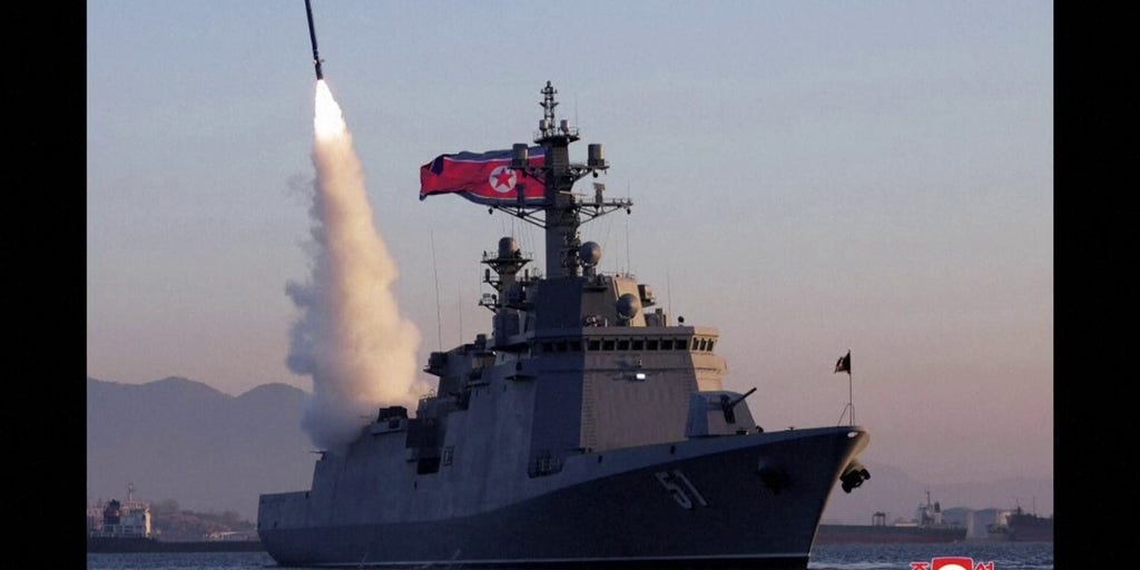 Photos show North Korea's Kim Jong Un observing missile tests from prized new warship