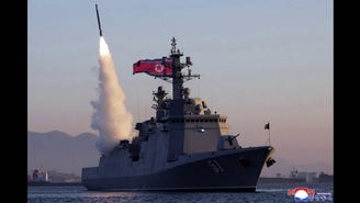 Photos show North Korea's Kim Jong Un observing missile tests from prized new warship