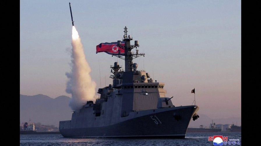 Photos show North Korea's Kim Jong Un observing missile tests from prized new warship