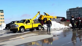 Heavy equipment flips over side of Wisconsin parking garage - Fox News