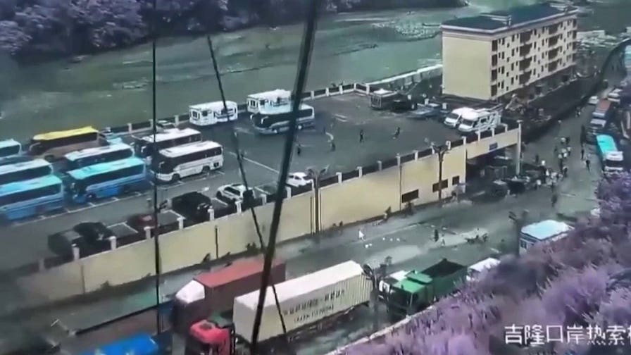Crowds run as violent mudslide sweeps the China-Nepal border