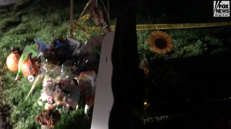 New large sign with Gabby Petito鈥檚 image hammered into makeshift memorial in her honor on the corner of the Laundrie property.