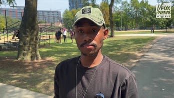 A pro-America counter-protester shares his views outside of the DNC