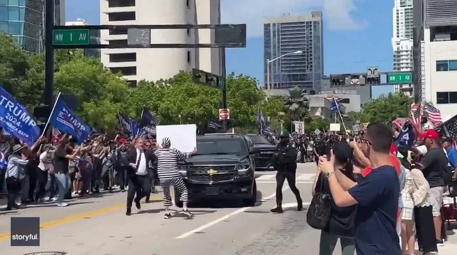 Protestor detained after running in front of Trump's motorcade