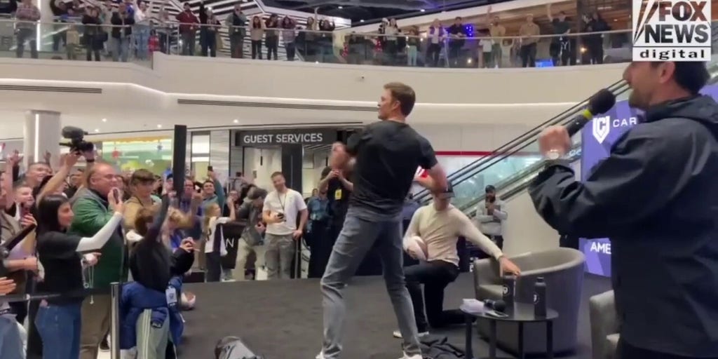 Tom Brady throws footballs as he opens up CardVault in New Jersey