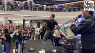 Tom Brady throws footballs as he opens up CardVault in New Jersey