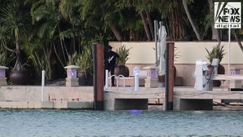 Sean "Diddy" Combs sits on the dock of his Star Island home.
