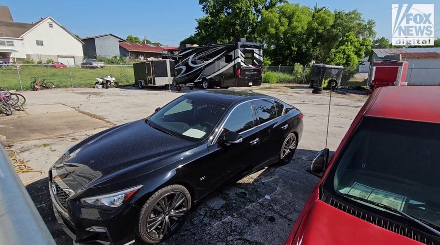Dr. John Forsyth's luxury RV, sedan in an impound lot