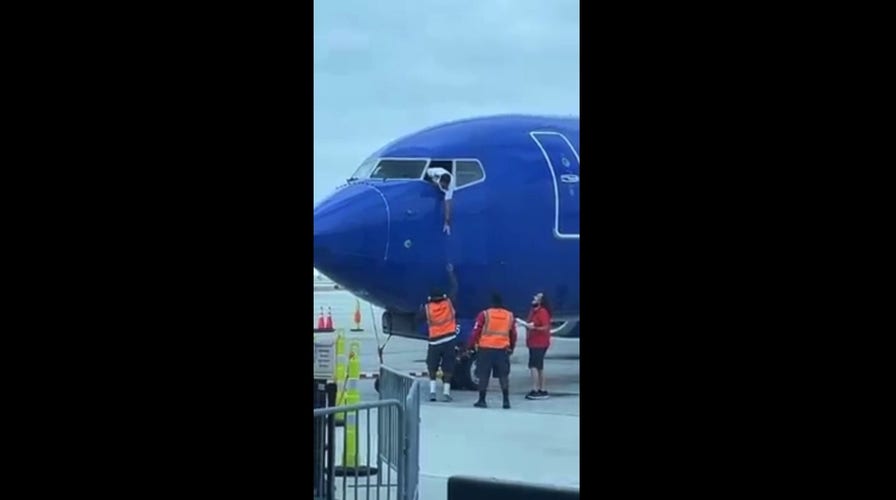 Southwest Airlines pilot hangs from window to retrieve passenger’s cell phone