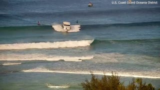 Boat surfs wave before running aground in Hawaii