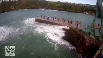 SEE IT: Child is swept off pier during high tide in petrifying moment — watch what happens