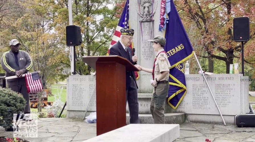 Young Dylan Smith of New York honors a World War II veteran this Veterans Day