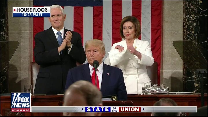 Nancy Pelosi tears up President Trump's speech script behind him as he finishes State of the Union