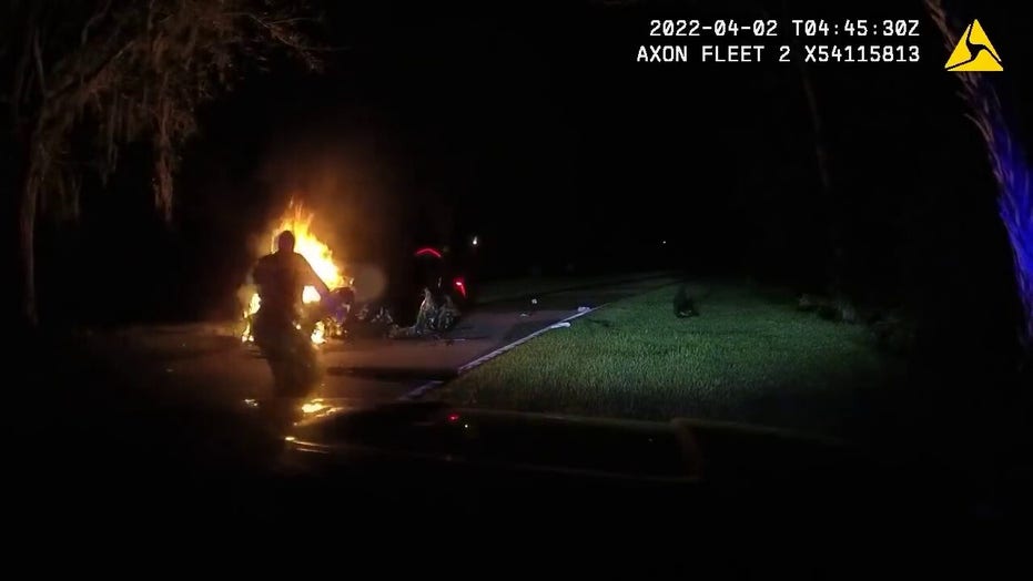 Florida police save man trapped inside burning vehicle