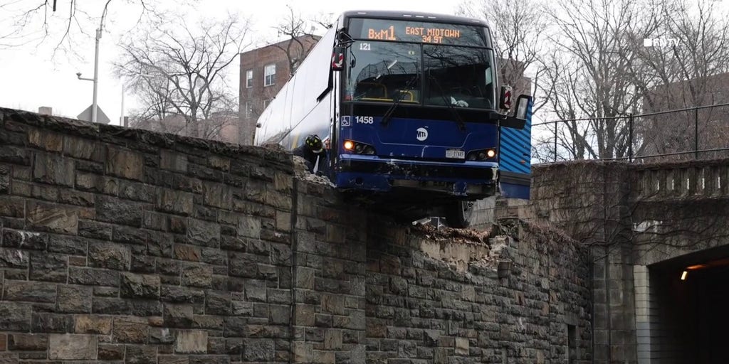 NYC MTA bus hangs precariously off overpass following collision