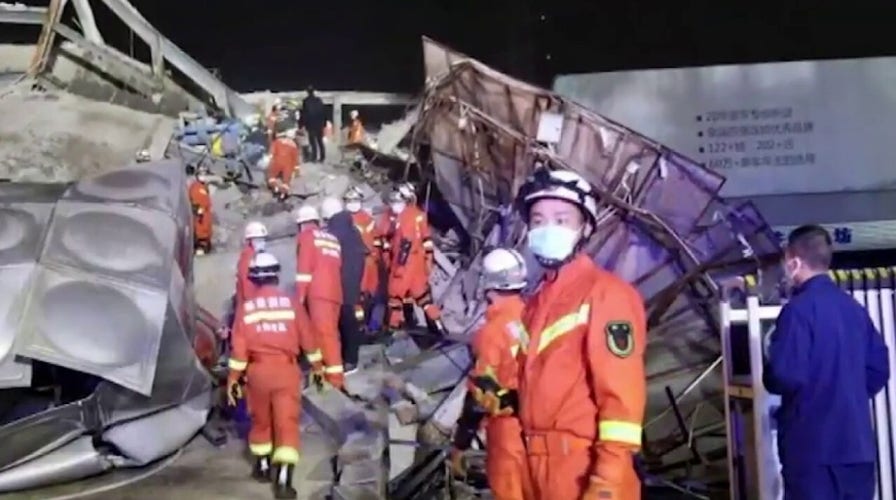 Rescue workers in China scramble to save people trapped in collapsed hotel set up for coronavirus containment