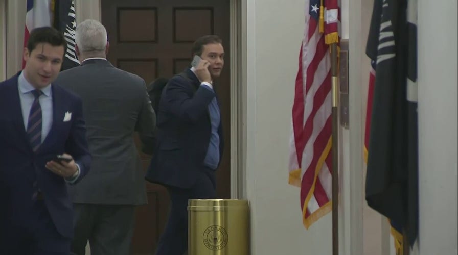 Rep.-elect George Santos avoids reporters as he arrives at Capitol Hill office