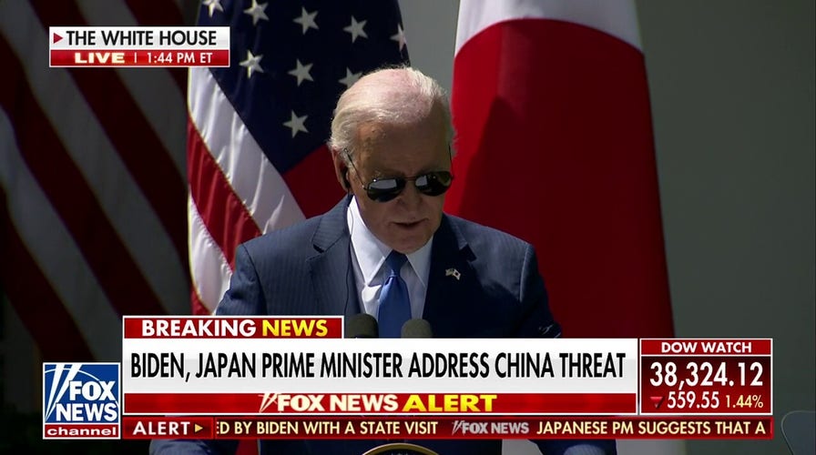 Biden glances down at notes, reporter list during press conference