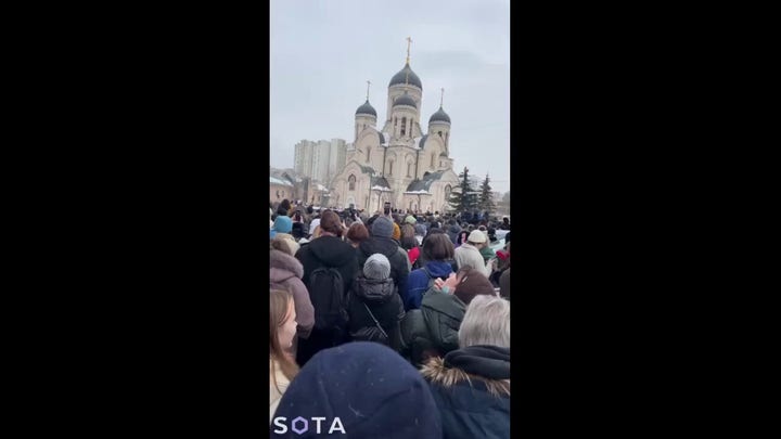 Supporters of Russian opposition leader Alexei Navalny chant his name outside Moscow church