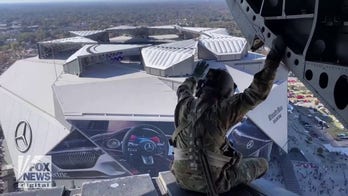 U.S. Army soldiers fly over football stadium for Call to Service game