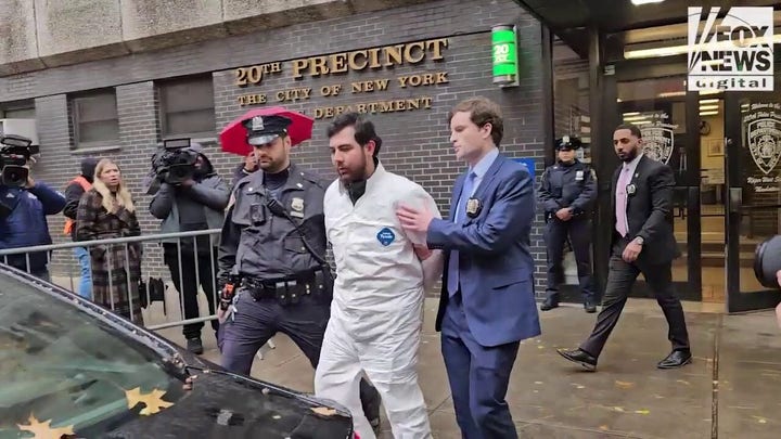 Joshua Zinberg is led from the 20th Precinct in New York City