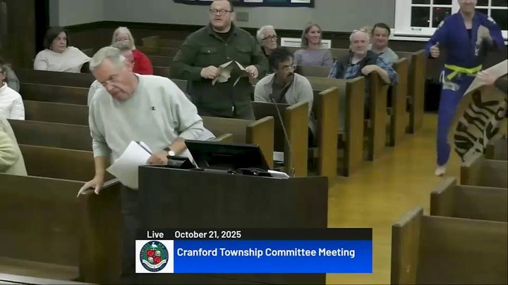 NJ candidate kung fu kicks protest signs in bizarre town hall meeting video