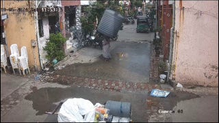 Woman escapes injury after water tank falls from building, lands perfectly around her - Fox News