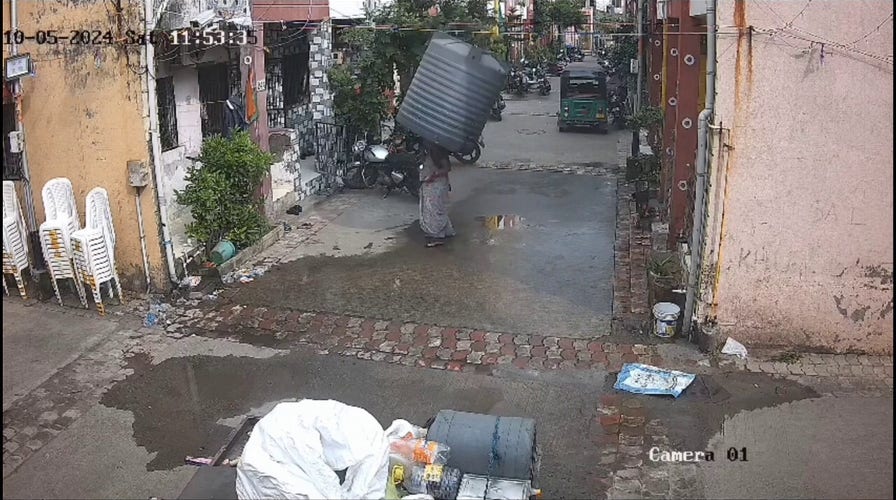 Woman escapes injury after water tank falls from building, lands perfectly around her