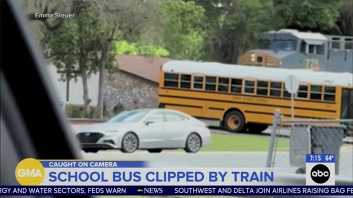 School bus in Florida is clipped by a train as it just makes it across the tracks