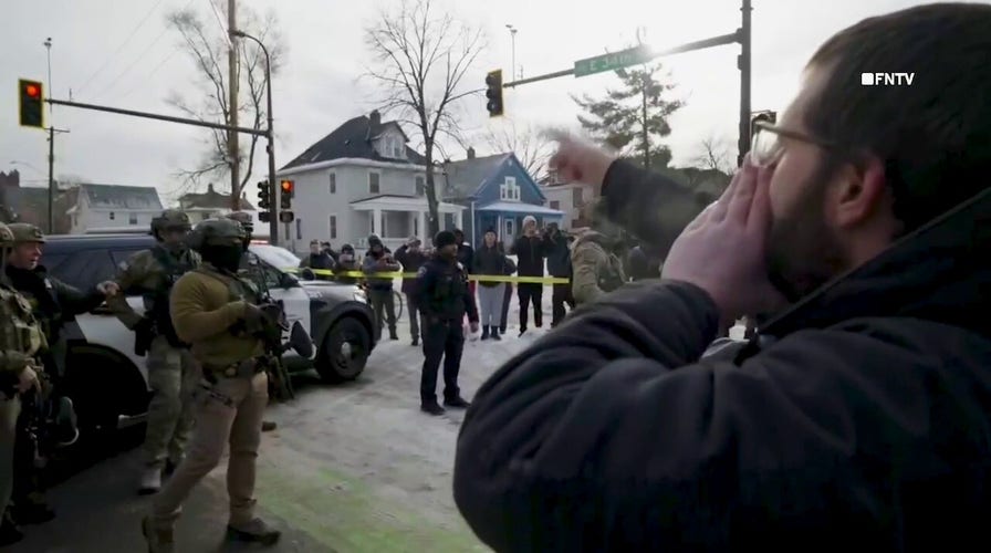 Angry protesters berate federal agents at Minneapolis shooting scene