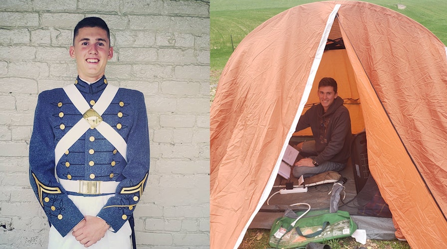 Military cadet finishes college schoolwork inside a tent