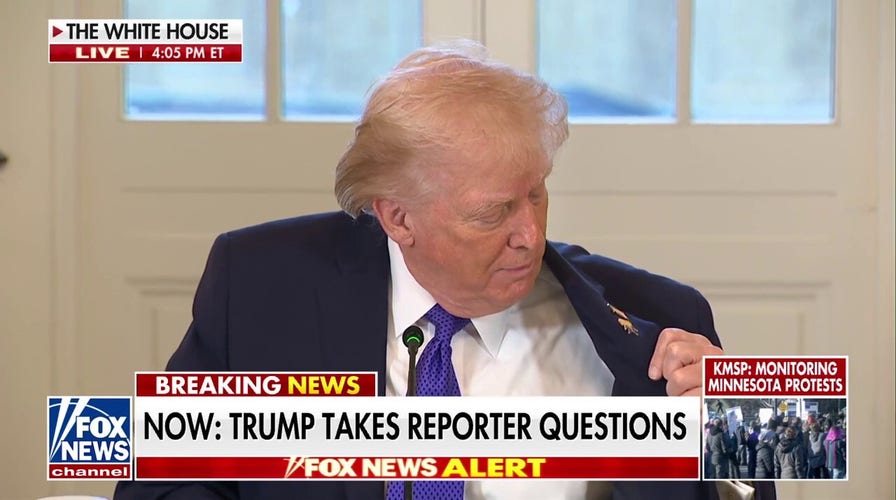 President Trump shows off his 'Happy Trump' pin