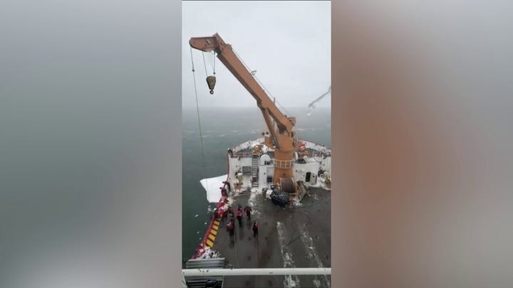 WATCH: Coast Guard crane hoists snowmobile off drifting ice on Lake Huron