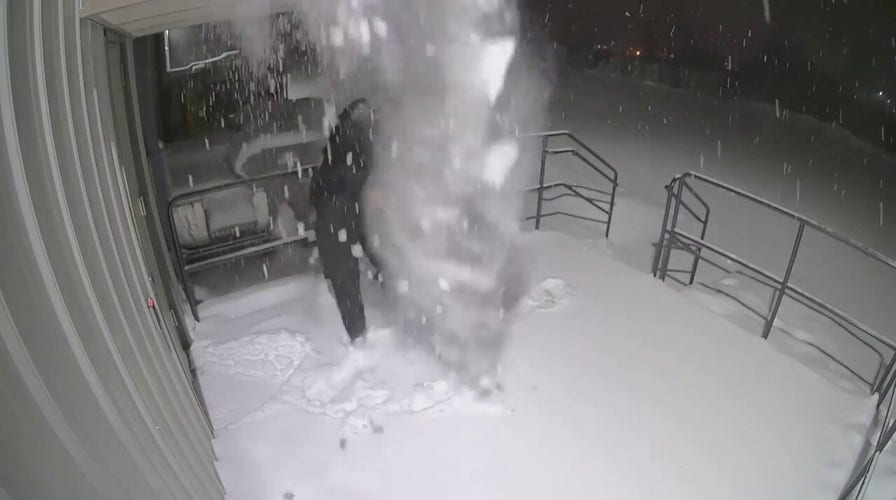 Wisconsin police officer gets snow dumped on him after closing door