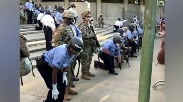 Police take a knee with protesters in Philadelphia, go on offense in Los Angeles