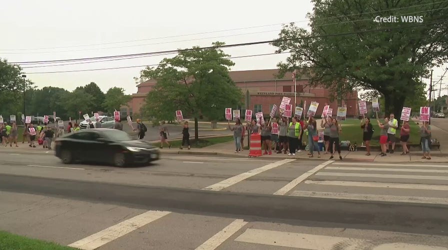 Ohio teachers union pickets outside a Columbus school following rejection of board proposal