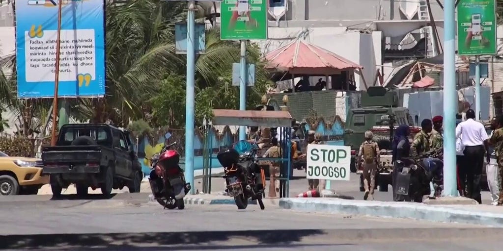 Sodiers guard the entrance of a hotel in Mogadishu, Somalia after a jihadist attack