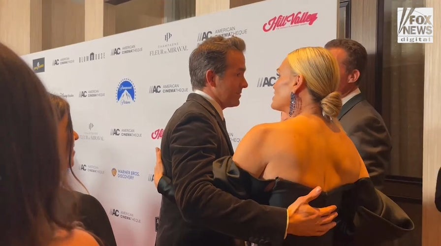 Ryan Reynolds hugs model Molly Sims at American Cinematheque Awards