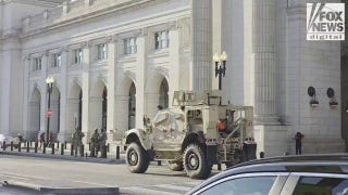 National Guard troops stand guard outside DC's Union Station as their presence ramps up in nation's capital