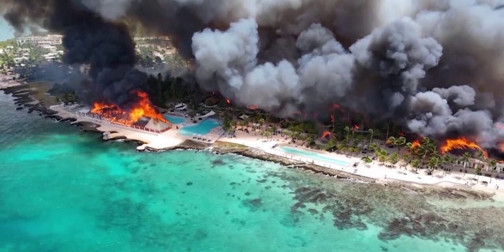 Flames blaze from a fire at the Dominican Republic resort town Bayahibe