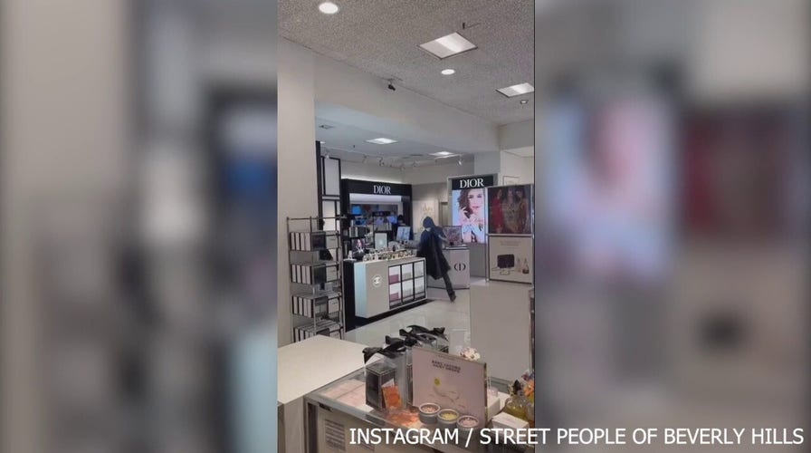 Masked thieves empty shelves at Macy’s as stunned shoppers look on