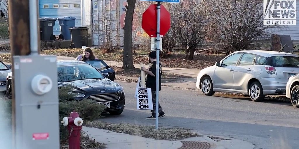 Party for Socialism and Liberation's Twin Cities chapter readies pre-made signs for 'No Kings' protest