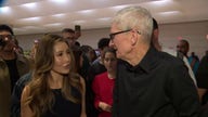 Apple CEO Tim Cook helps sell iPhone 17