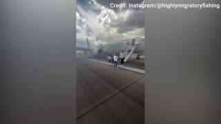  Passengers evacuate American Airlines aircraft after landing gear issue at Denver airport - Fox Business Video