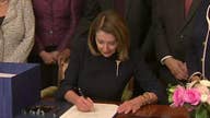 Nancy Pelosi signs spending bill
