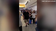 Hundreds of travelers stand in customer service line at Newark Airport