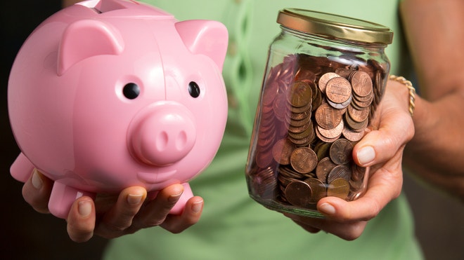 Hands holding piggy bank and jar of pennies