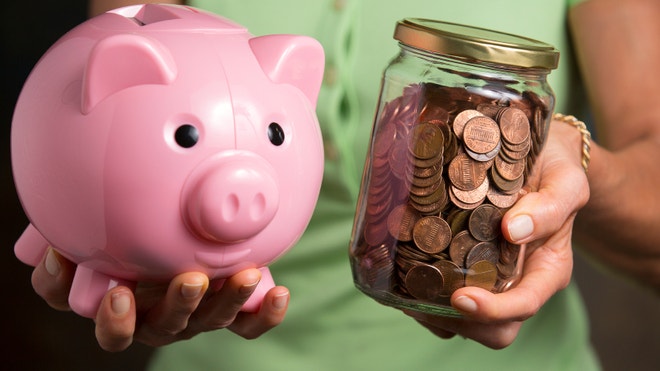 Hands holding piggy bank and jar of pennies